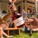 A Courvoisier VS bottle being passed between two hands at a house party, from the Pass The Courvoisier campaign